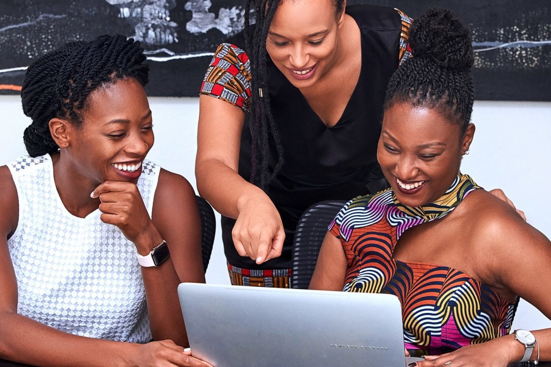 ladies viewing something on a laptop